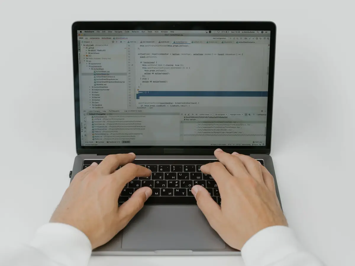 Developer writing API integration code on a laptop